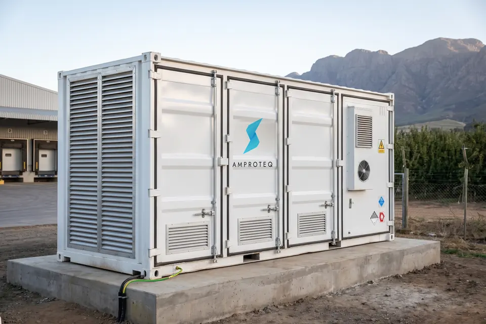 An AMPROTEQ A200 20 ft battery container beside a fruit packhouse